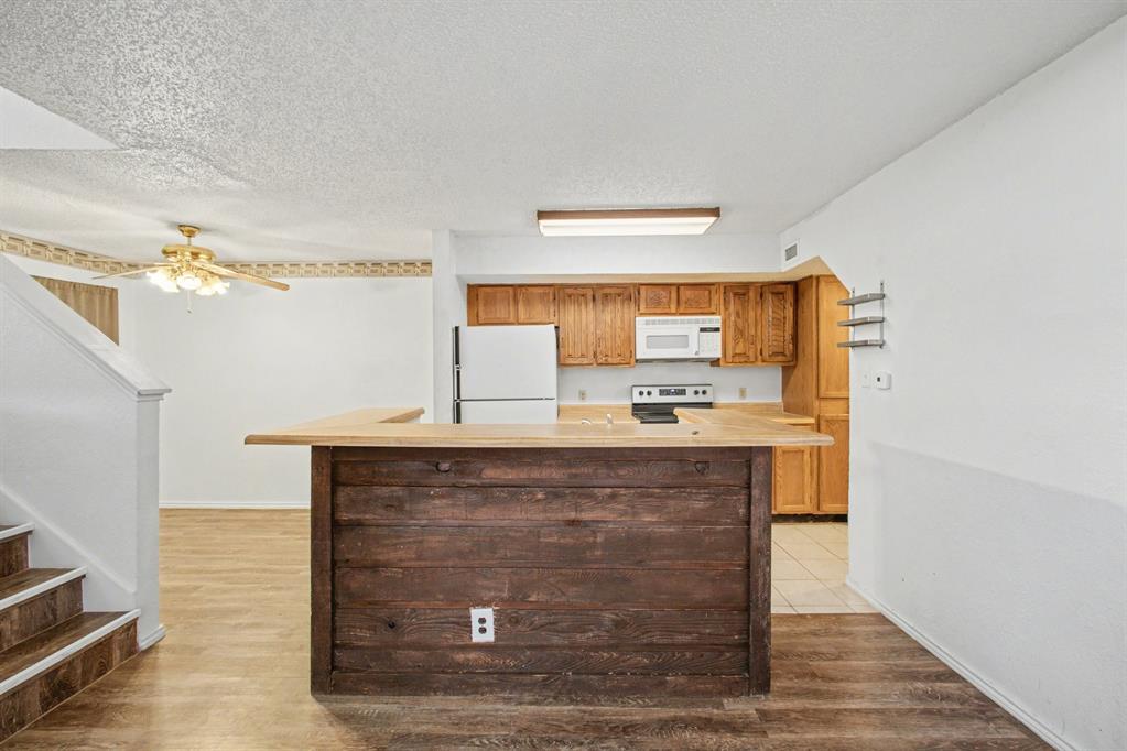 9827 Walnut Street, Unit 210 Dallas, TX 75243 - Photo 13 of 30 a view of living room with granite countertop furniture and fireplace