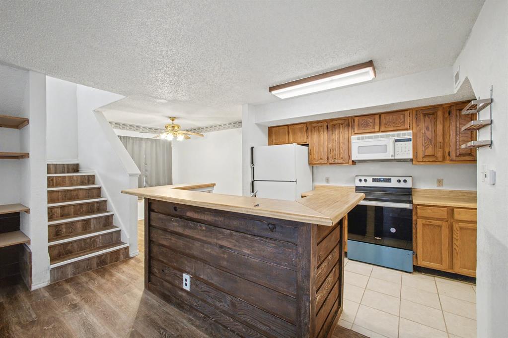 9827 Walnut Street, Unit 210 Dallas, TX 75243 - Photo 14 of 30 a kitchen with a stove and a sink