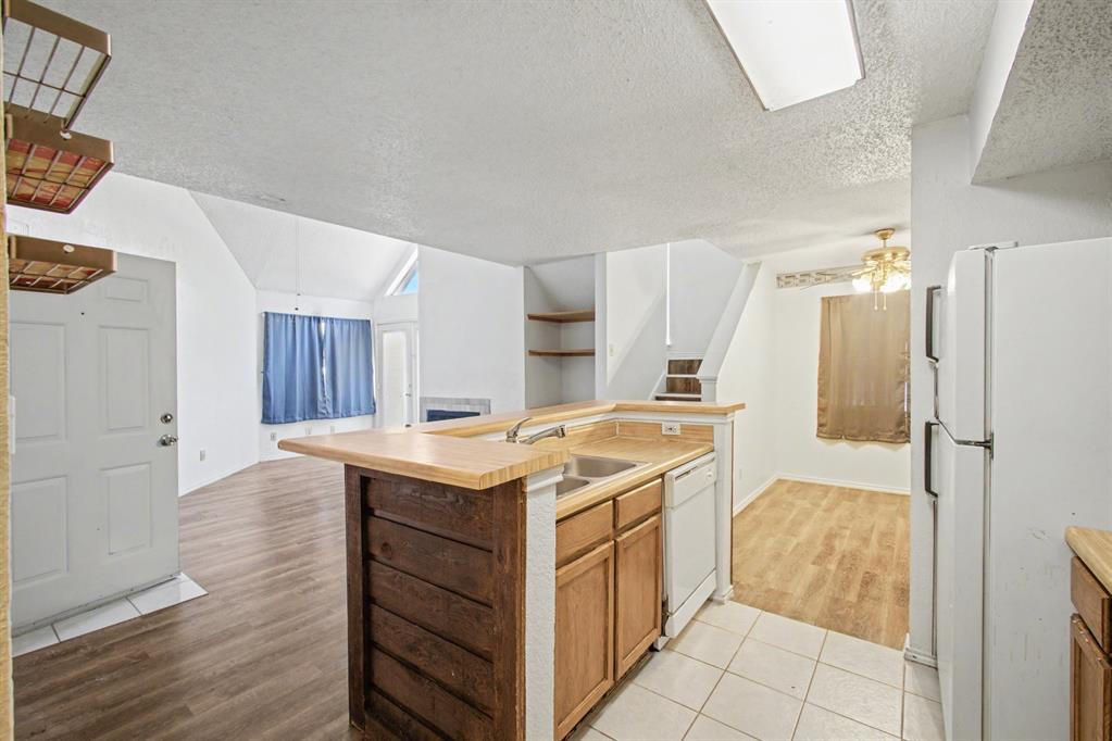 9827 Walnut Street, Unit 210 Dallas, TX 75243 - Photo 15 of 30 a view of a kitchen cabinets and wooden floor