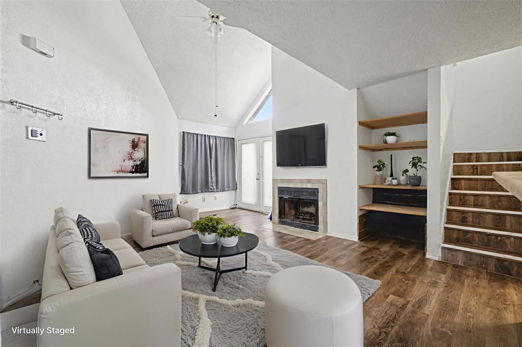 9827 Walnut Street, Unit 210 Dallas, TX 75243 - Photo 18 of 30 a living room with furniture a fireplace and a flat screen tv