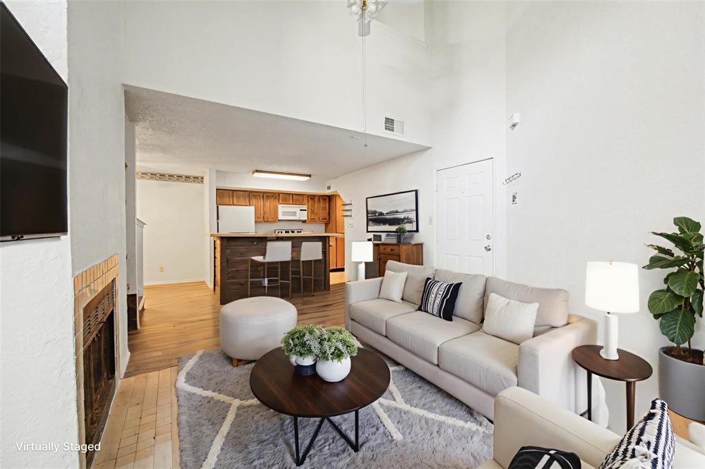 9827 Walnut Street, Unit 210 Dallas, TX 75243 - Photo 20 of 30 a living room with furniture a flat screen tv and a fireplace