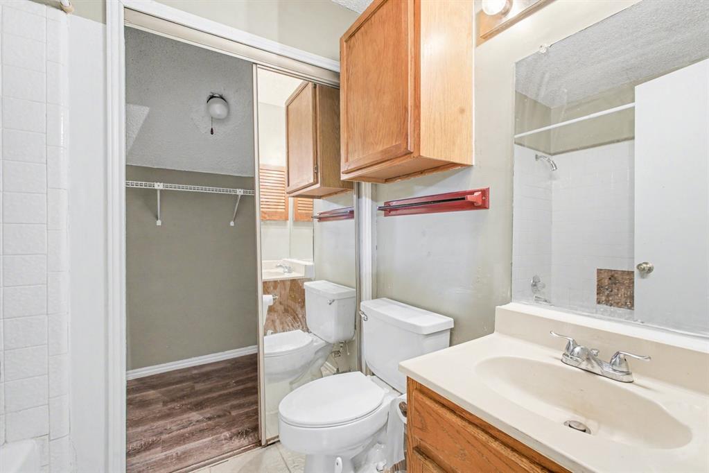 9827 Walnut Street, Unit 210 Dallas, TX 75243 - Photo 23 of 30 a bathroom with a sink a toilet and shower