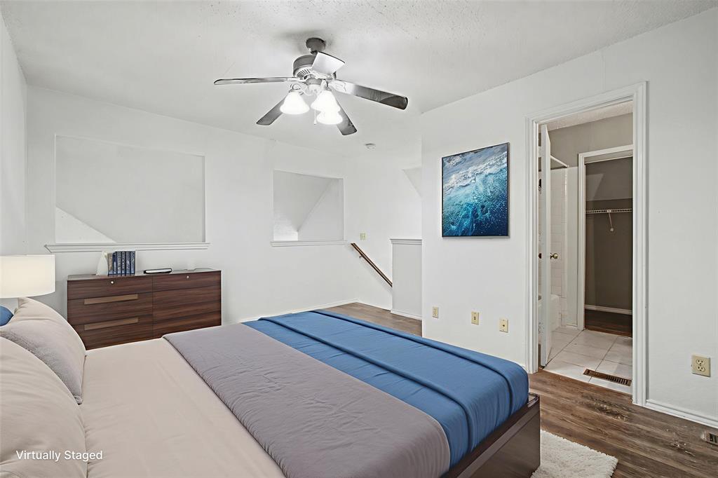 9827 Walnut Street, Unit 210 Dallas, TX 75243 - Photo 4 of 30 a bedroom with a bed and a chandelier