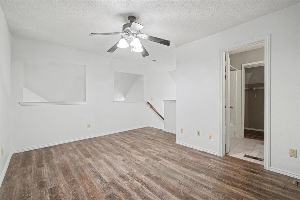 9827 Walnut Street, Unit 210 Dallas, TX 75243 - Photo 5 of 30 a view of empty room with wooden floor