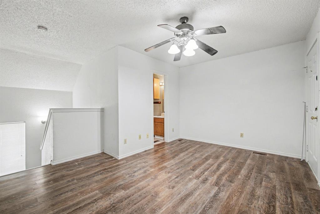 9827 Walnut Street, Unit 210 Dallas, TX 75243 - Photo 6 of 30 a view of an empty room with wooden floor