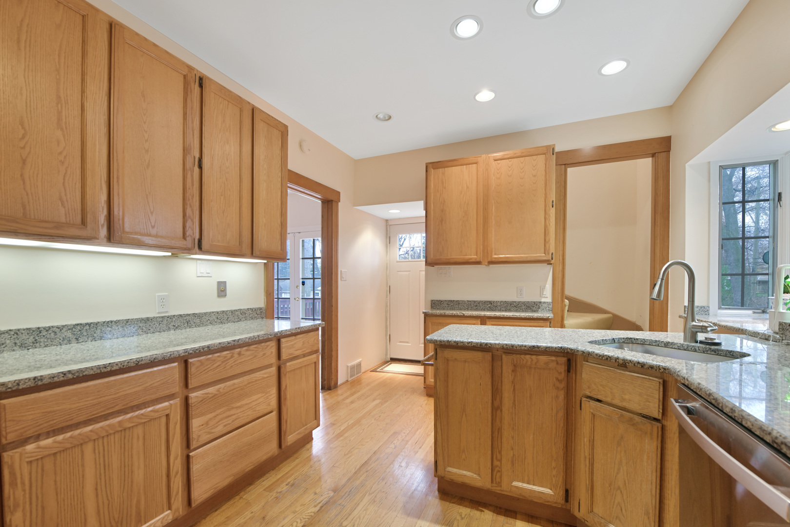1726 Wesley Avenue Evanston, IL 60201 - Photo 12 of 27 a kitchen with granite countertop wooden cabinets a sink and dishwasher