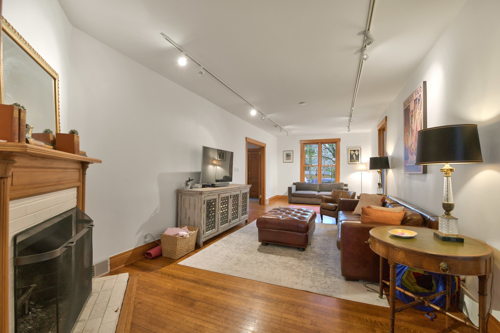 1726 Wesley Avenue Evanston, IL 60201 - Photo 7 of 27 a living room with furniture a fireplace and a flat screen tv