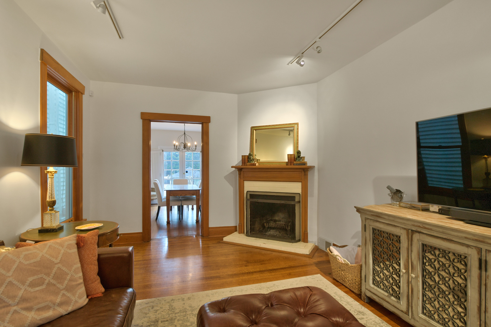 1726 Wesley Avenue Evanston, IL 60201 - Photo 8 of 27 a living room with furniture a fireplace and a flat screen tv