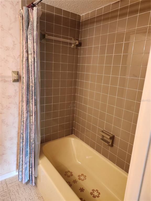 2437 Harbor Boulevard, Unit 213 Port Charlotte, FL 33952 - Photo 11 of 12 a bathroom with a bathtub