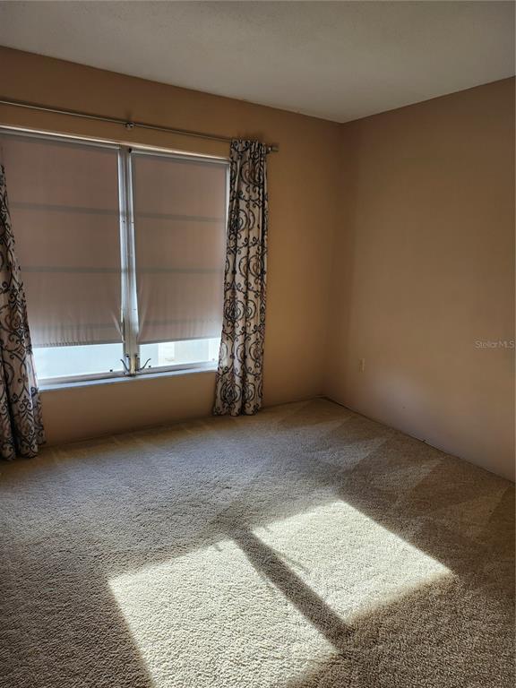 2437 Harbor Boulevard, Unit 213 Port Charlotte, FL 33952 - Photo 12 of 12 an empty room with windows