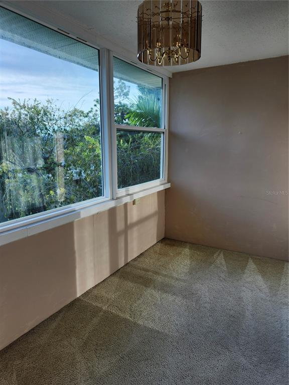 2437 Harbor Boulevard, Unit 213 Port Charlotte, FL 33952 - Photo 7 of 12 a view of an empty room with a window