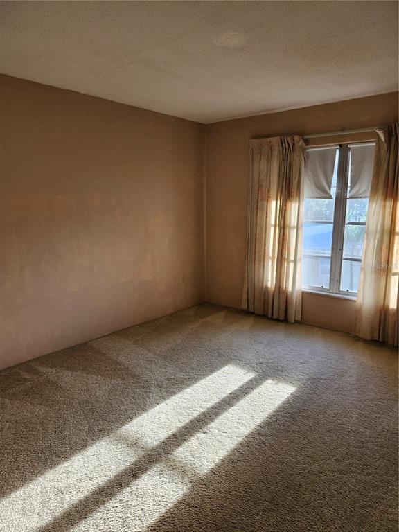 2437 Harbor Boulevard, Unit 213 Port Charlotte, FL 33952 - Photo 8 of 12 a view of an empty room with a window