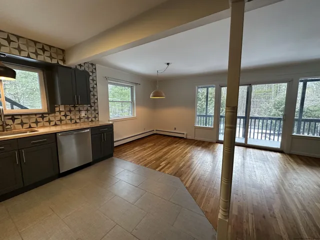 a view of a kitchen with a sink and a large window