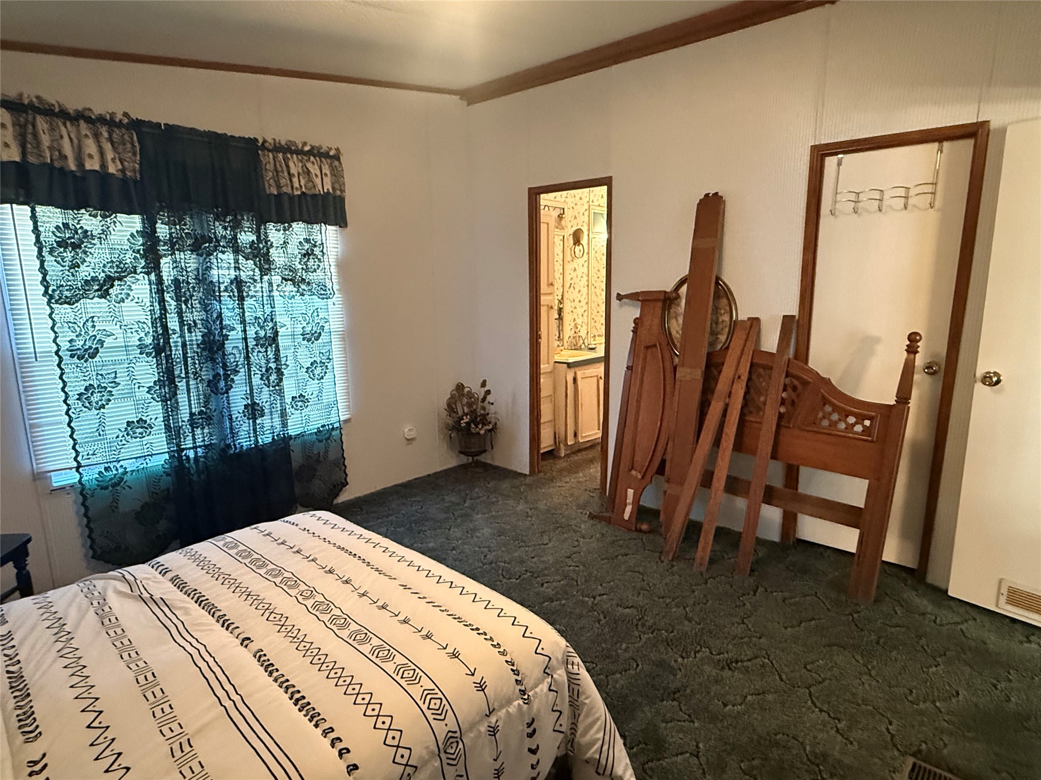 305 Canadian Drive Trinity, TX 75862 - Photo 18 of 29 a bedroom with a bed a mirror and a window