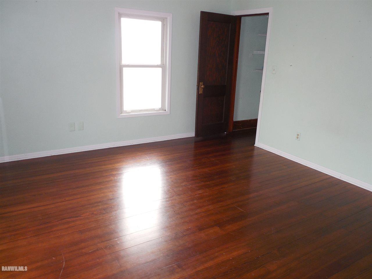 2638 North Crossroads Road Lena, IL 61048 - Photo 11 of 19 an empty room with wooden floor and windows