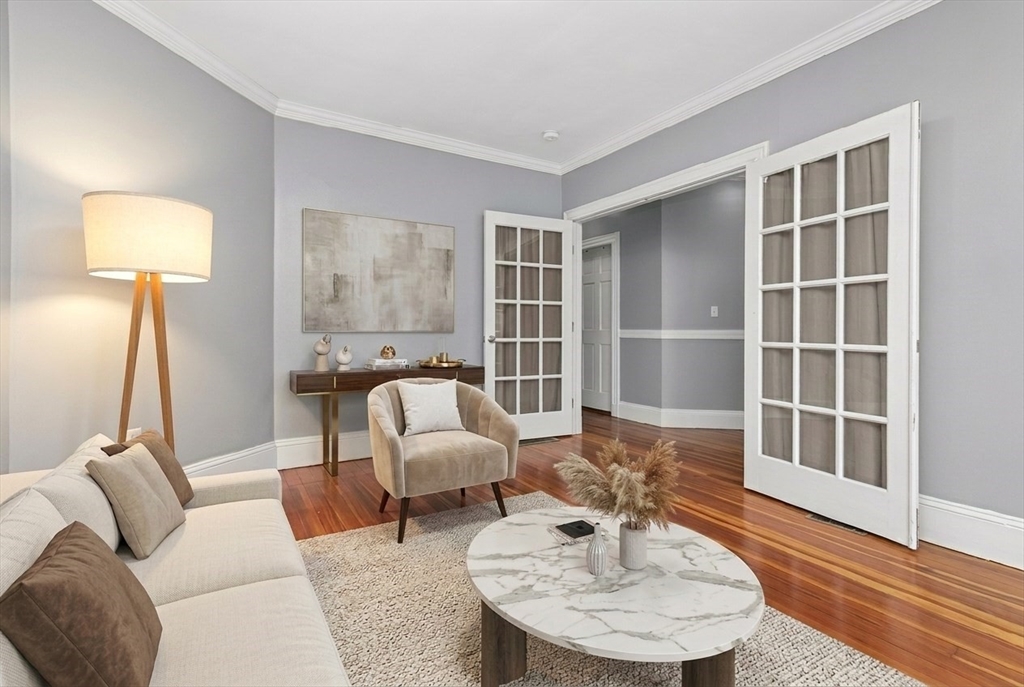 a living room with furniture and a lamp
