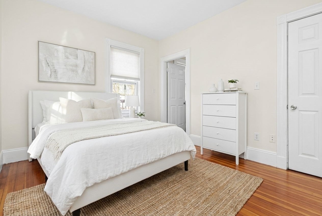 8 Taft Street, Unit 1 Boston, MA 02125 - Photo 11 of 25 a bedroom with a bed and a painting on the wall