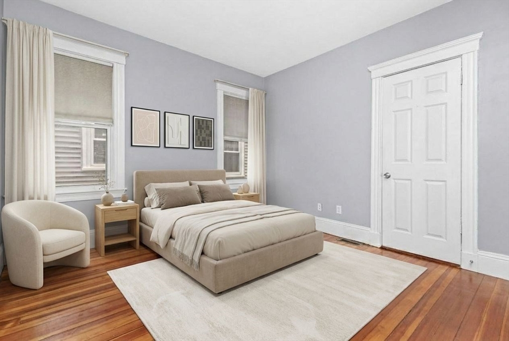 8 Taft Street, Unit 1 Boston, MA 02125 - Photo 12 of 25 a spacious bedroom with a bed and a couch
