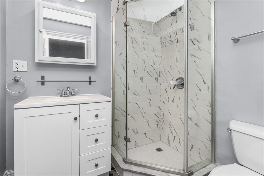8 Taft Street, Unit 1 Boston, MA 02125 - Photo 13 of 25 a bathroom with a shower a sink and a mirror