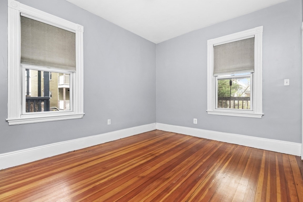 8 Taft Street, Unit 1 Boston, MA 02125 - Photo 20 of 25 a view of an empty room with wooden floor and a window