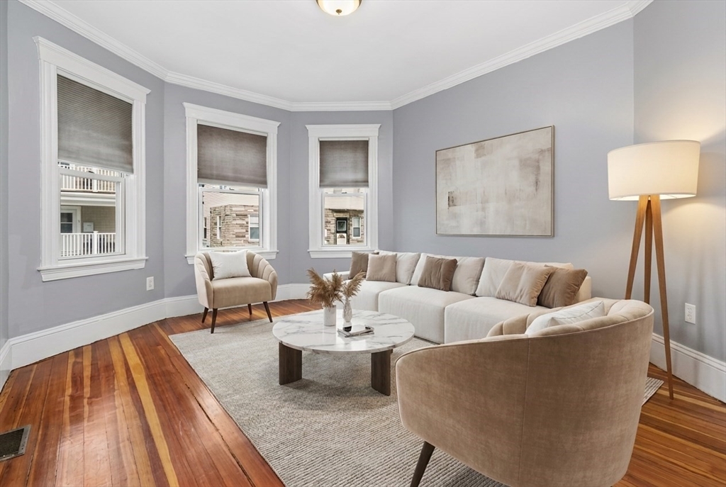 8 Taft Street, Unit 1 Boston, MA 02125 - Photo 2 of 25 a living room with furniture and a window