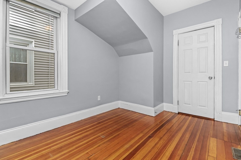 8 Taft Street, Unit 1 Boston, MA 02125 - Photo 22 of 25 a view of empty room with wooden floor and fan