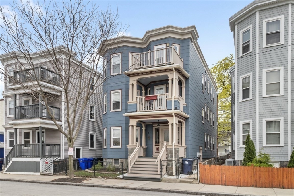 8 Taft Street, Unit 1 Boston, MA 02125 - Photo 23 of 25 a front view of a residential apartment building with a yard