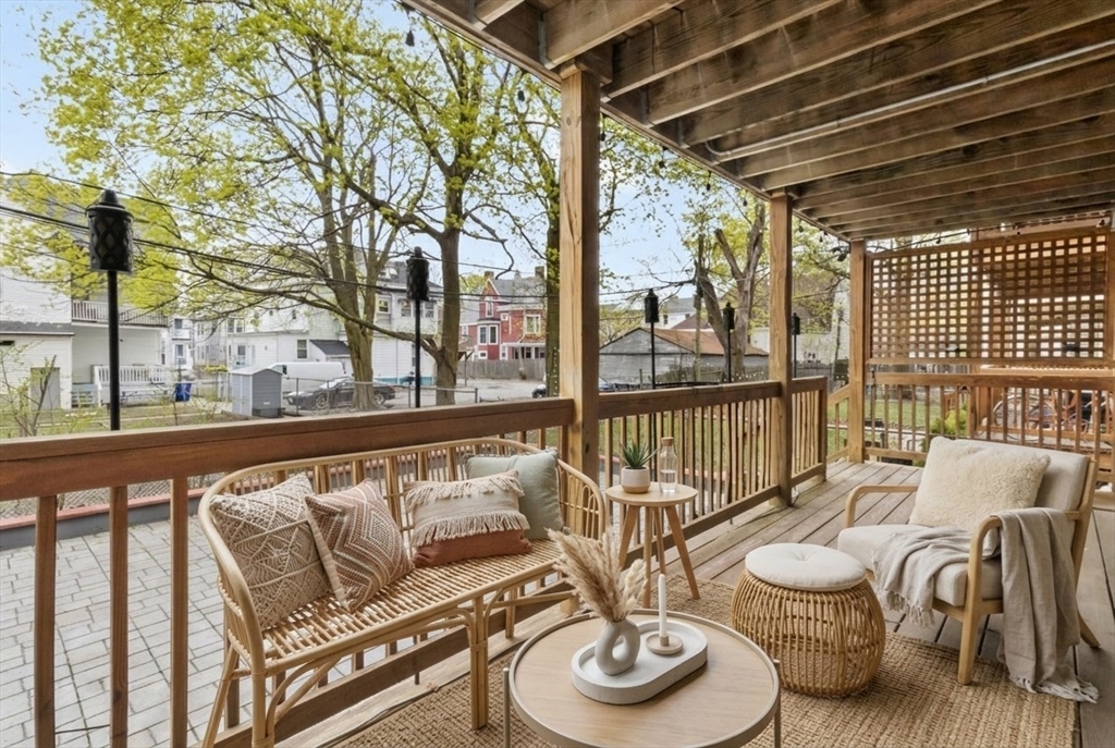8 Taft Street, Unit 1 Boston, MA 02125 - Photo 3 of 25 a view of a balcony with chairs and wooden floor