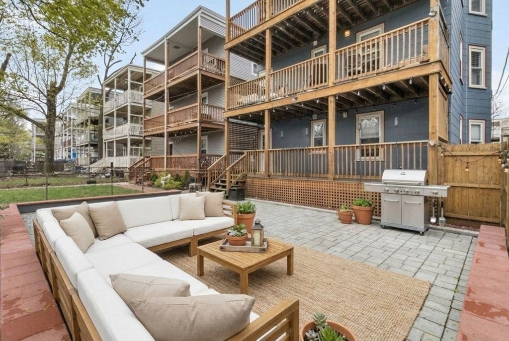 8 Taft Street, Unit 1 Boston, MA 02125 - Photo 4 of 25 a view of a patio with couches and a table and chairs