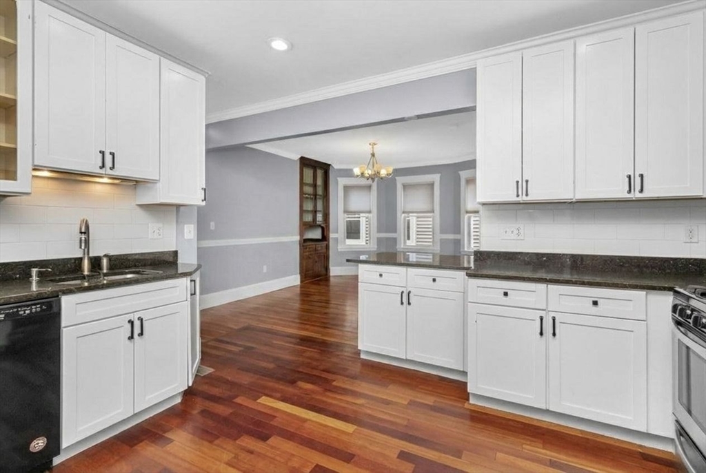 8 Taft Street, Unit 1 Boston, MA 02125 - Photo 7 of 25 a kitchen with granite countertop white cabinets and white appliances
