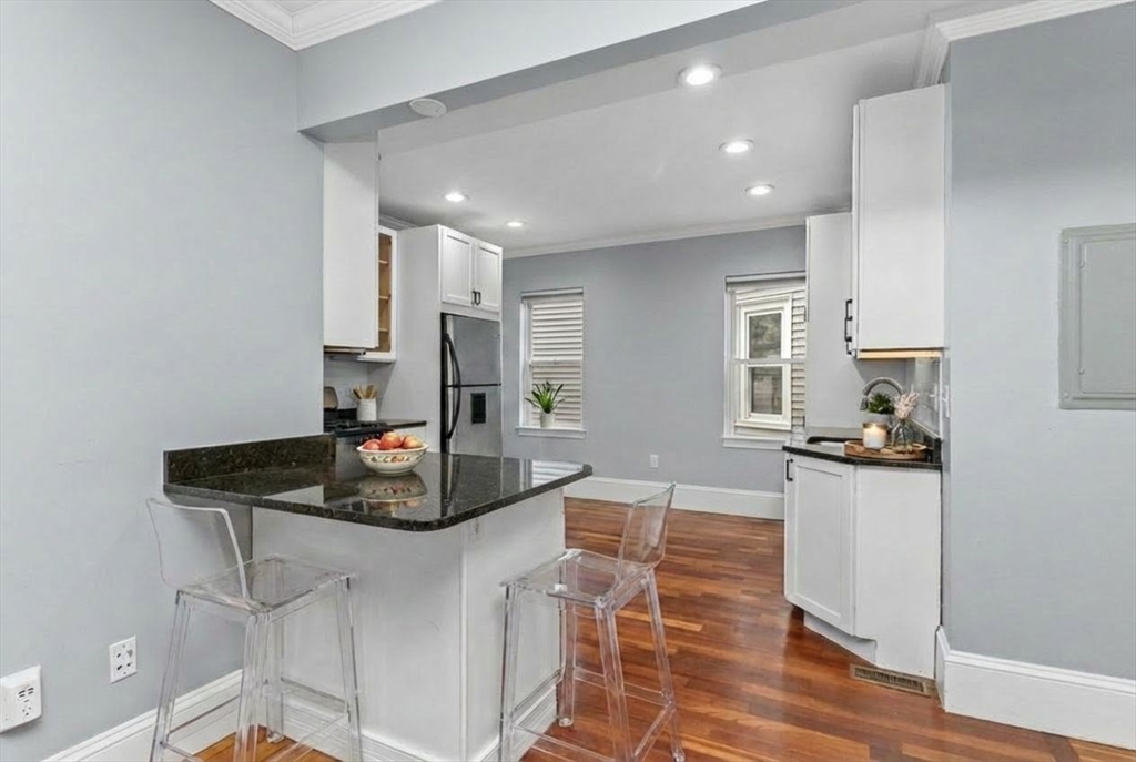 8 Taft Street, Unit 1 Boston, MA 02125 - Photo 8 of 25 a kitchen with stainless steel appliances granite countertop a sink and stove