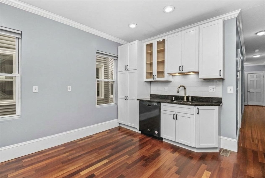 8 Taft Street, Unit 1 Boston, MA 02125 - Photo 10 of 25 a kitchen with stainless steel appliances granite countertop a stove a sink and a refrigerator