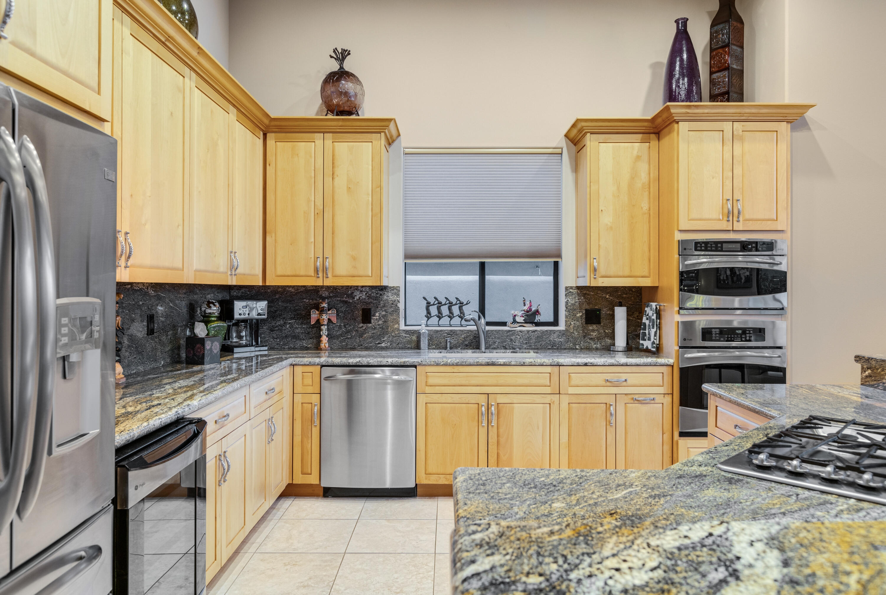 7 Nebulae Way Rancho Mirage, CA 92270 - Photo 15 of 40 a kitchen with stainless steel appliances granite countertop a sink and cabinets