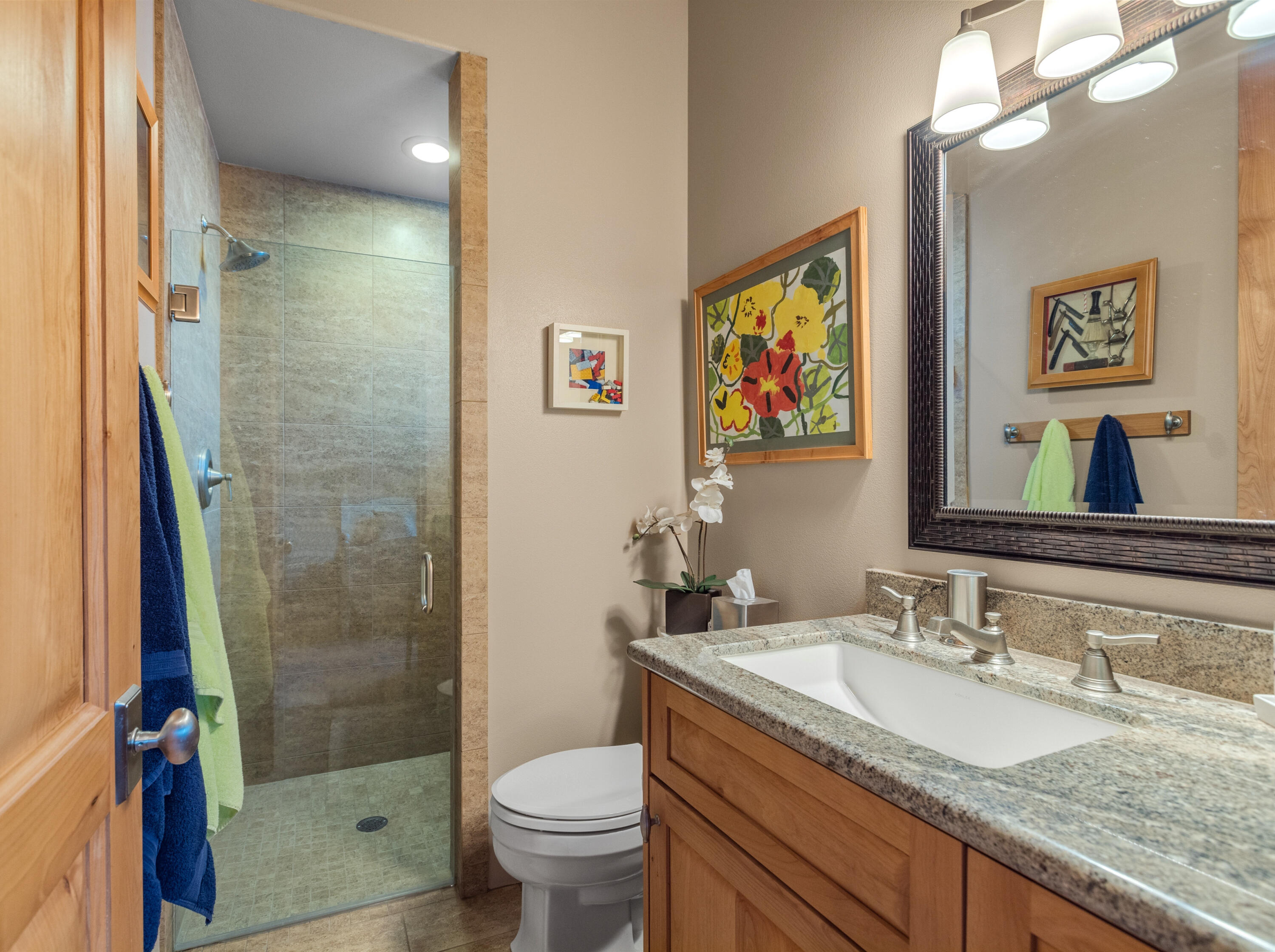 7 Nebulae Way Rancho Mirage, CA 92270 - Photo 22 of 40 a bathroom with a granite countertop sink a toilet a mirror a vanity and shower