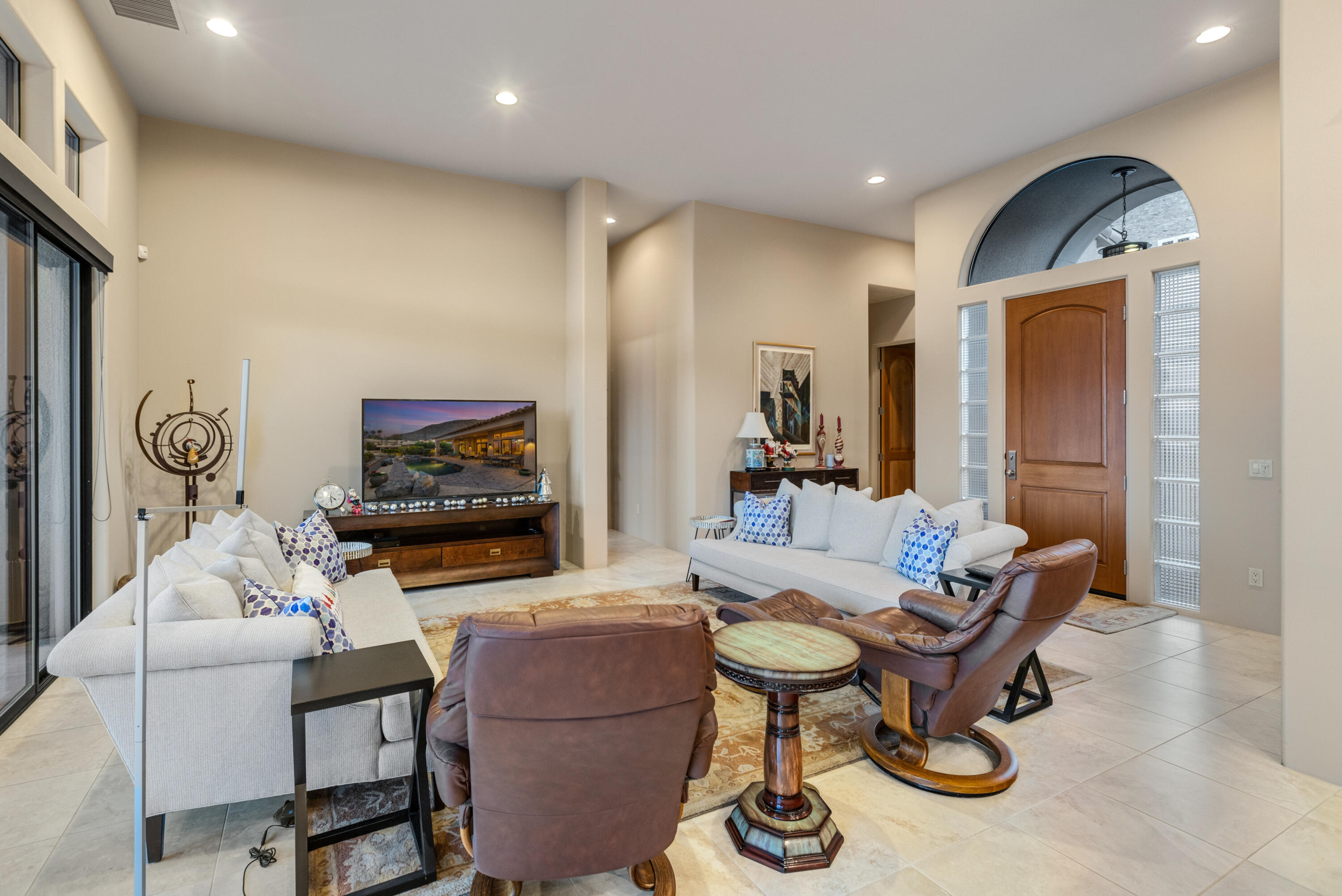 7 Nebulae Way Rancho Mirage, CA 92270 - Photo 7 of 40 a living room with furniture a flat screen tv and a fireplace