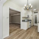 a kitchen with kitchen island granite countertop a refrigerator and a stove top oven