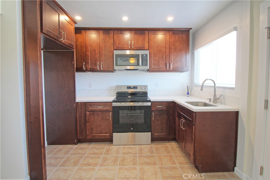 719 East Ramsey Street, Unit 3 Banning, CA 92220 - Photo 4 of 7 a kitchen with a sink cabinets and stainless steel appliances