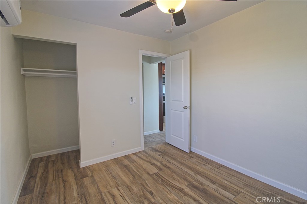 719 East Ramsey Street, Unit 3 Banning, CA 92220 - Photo 6 of 7 an empty room with closet and a ceiling fan