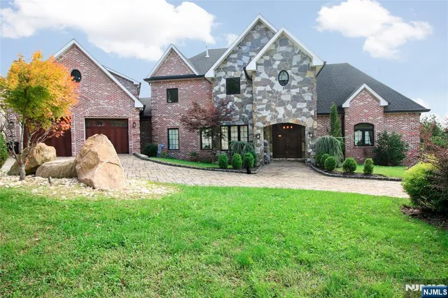 a front view of a house with a yard and garage