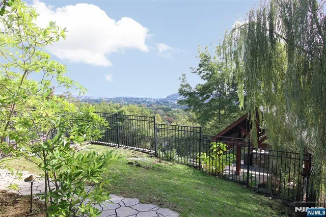 a view of a pathway with a wrought fence