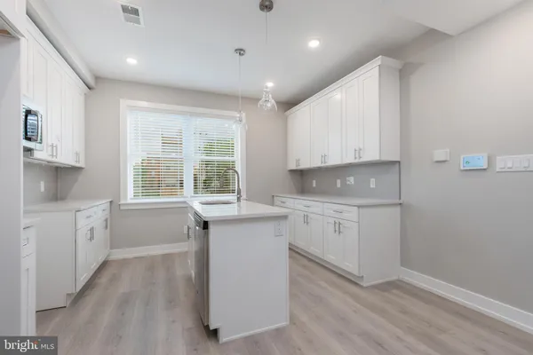 a kitchen with sink cabinets and window