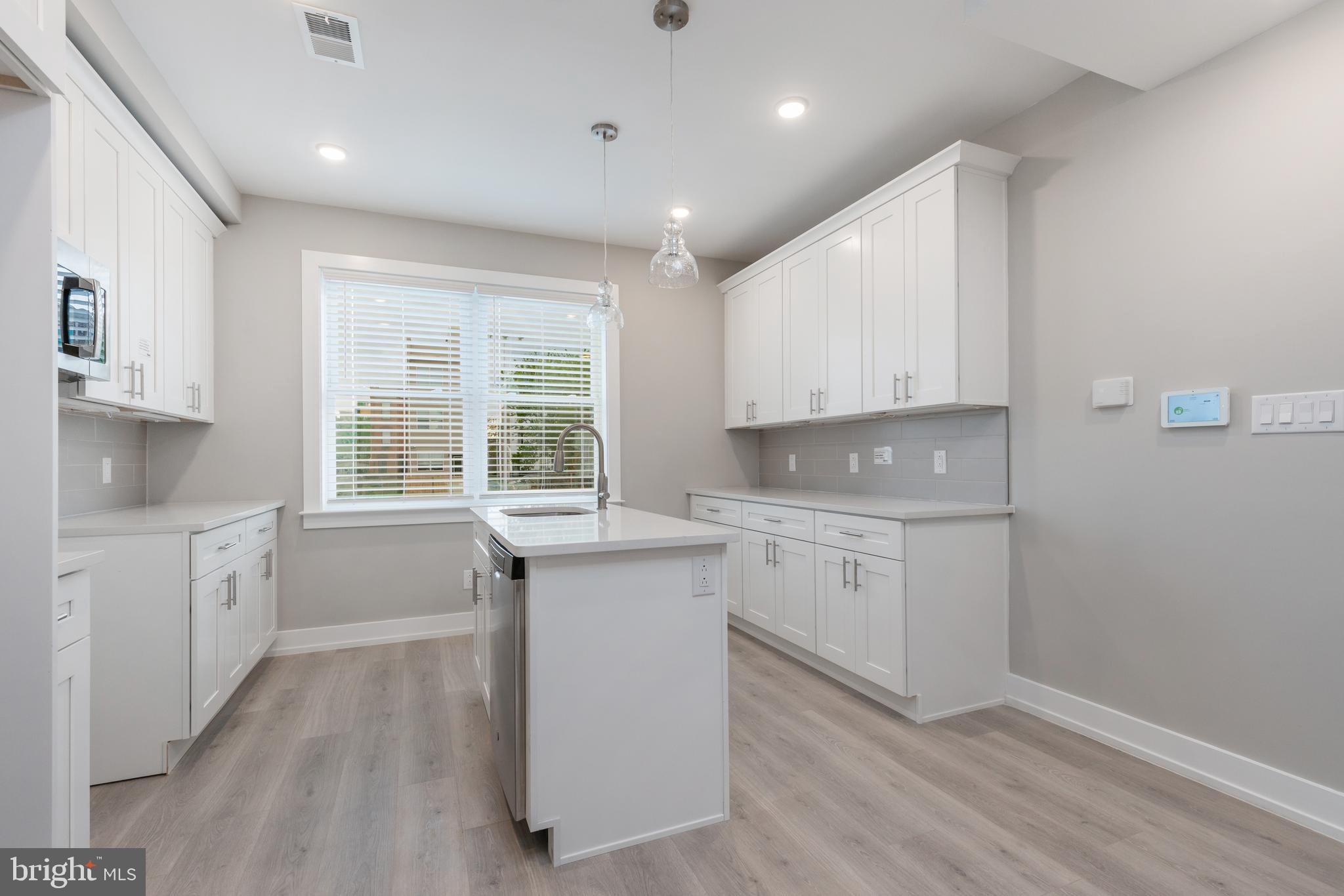 2530 North Howard Street, Unit 2 Philadelphia, PA 19133 - Photo 2 of 22 a kitchen with sink cabinets and window