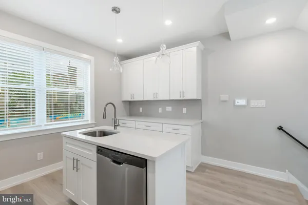 a view of a kitchen sink and a window