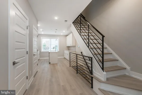 a view of entryway and hall with wooden floor