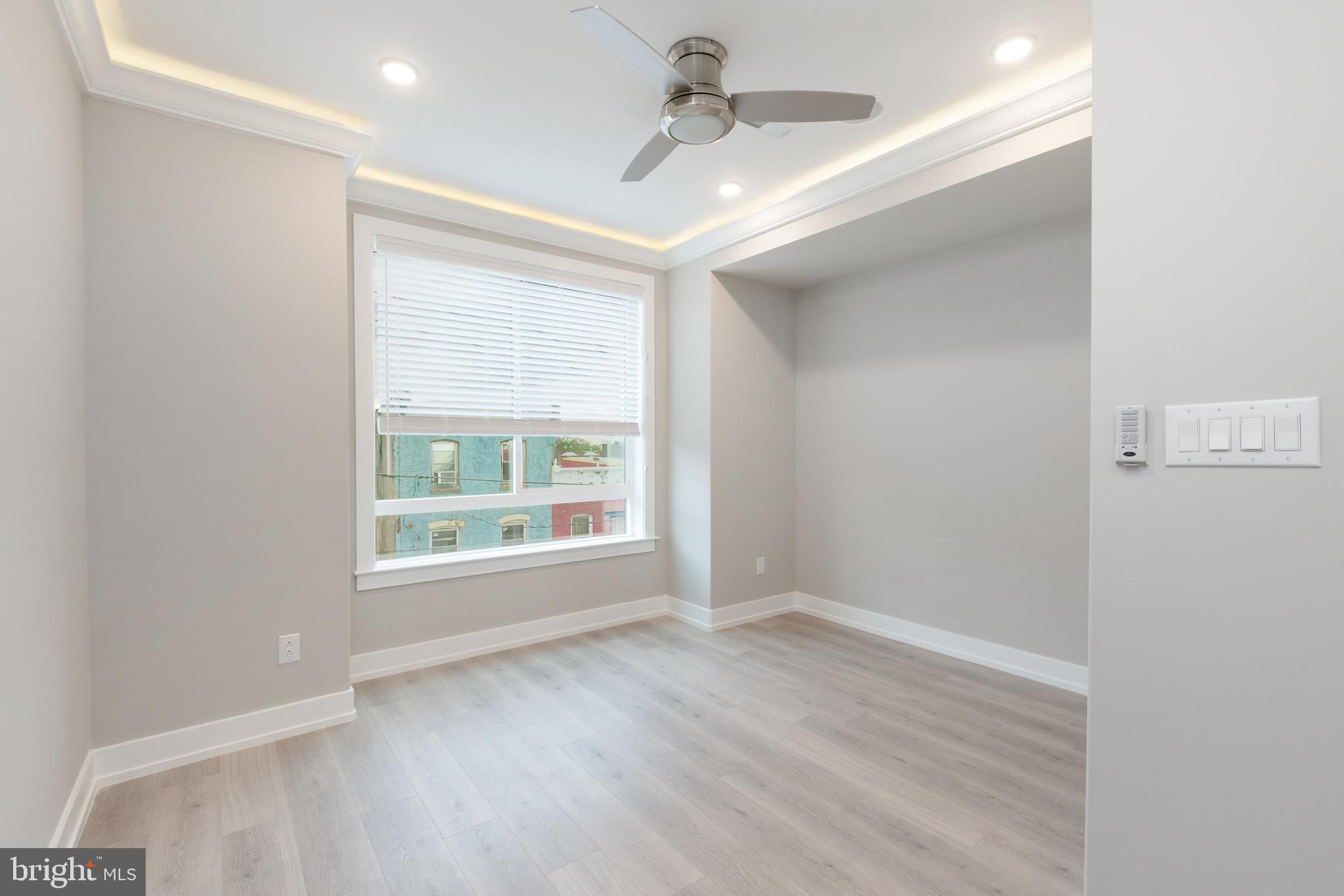 2530 North Howard Street, Unit 2 Philadelphia, PA 19133 - Photo 8 of 22 an empty room with wooden floor and windows