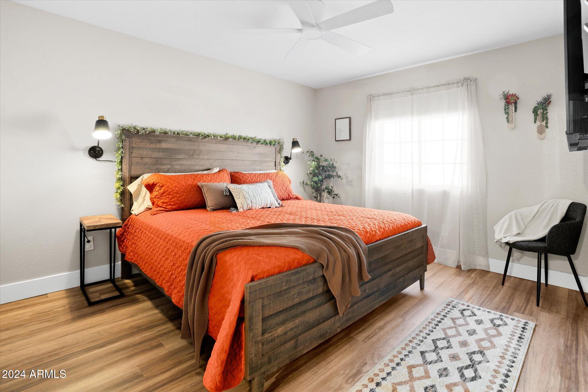 533 West Guadalupe Road, Unit 1063 Mesa, AZ 85210 - Photo 27 of 57 a bedroom with a bed and a chair