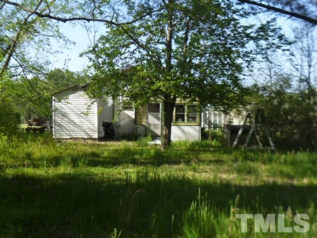 508 Belgreen Road Durham, NC 27713 - Photo 6 of 7 a backyard of a house with lots of green space and plants