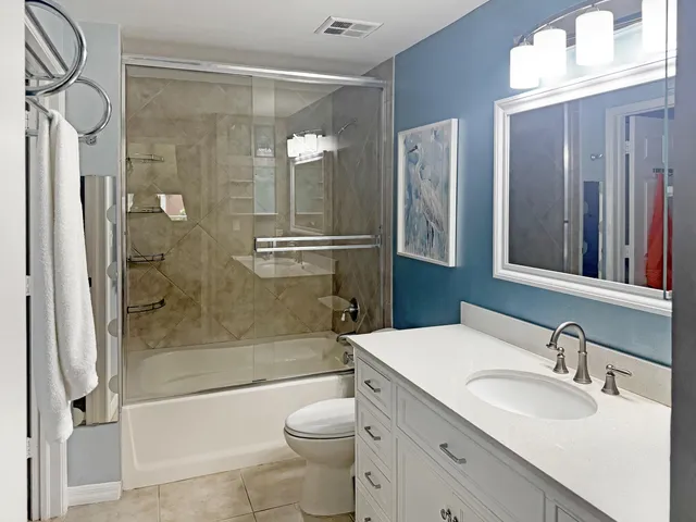 a living room with furniture and a view of kitchen