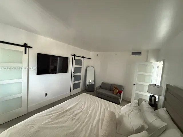 a bedroom with a bed and a television in it