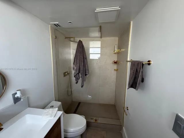 a bathroom with a toilet a sink and a mirror